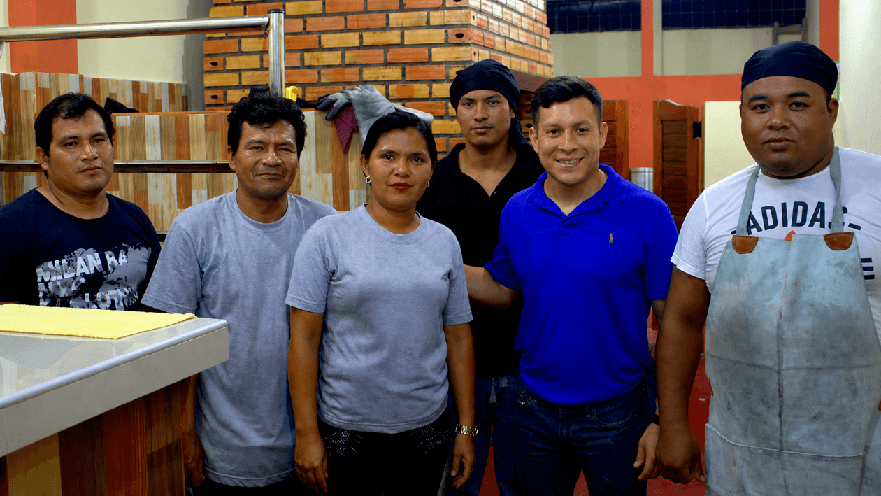 Walter Del Castillo (in blue) with his team at the rotisserie in Iquitos, Peru
